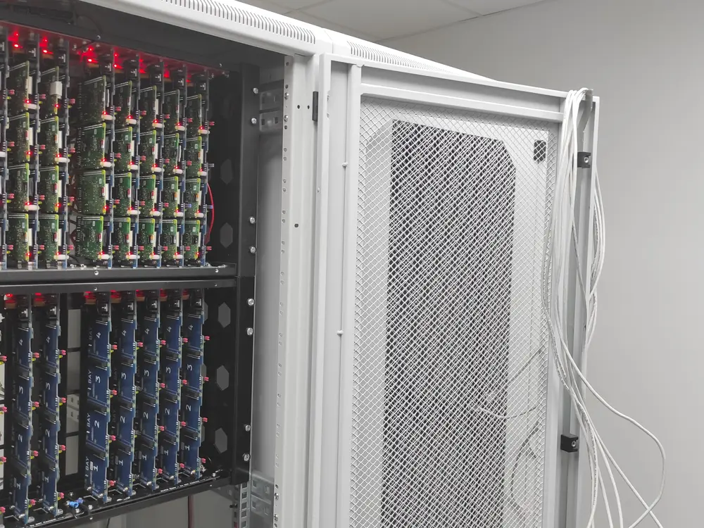 An open rack with dozens of connected Raspberry Pis and free slots